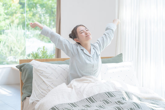 Asian woman wakes up in the bedroom.